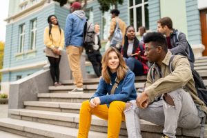 Student friends sitting together and having a conversation