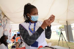 A healthcare worker prepares to administer the Pfizer...