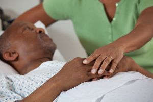 Black wife comforting husband in hospital