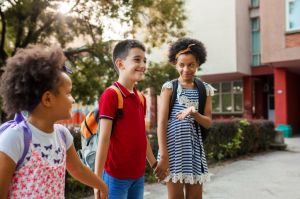 Three elementary school friends going to school