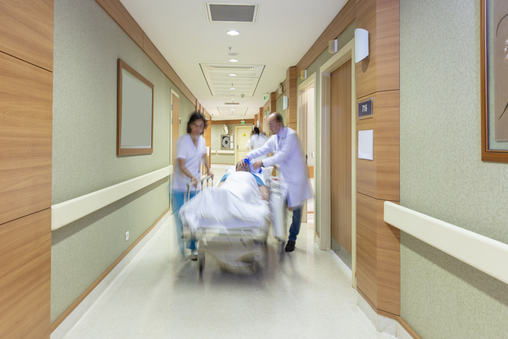 Doctor wheeling patient