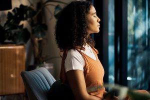 Meditation, home and peace for relax girl with closed eyes for wellness, calm and spiritual freedom or health. Black woman meditate, breathing training exercise for healthy mindset and stress relief