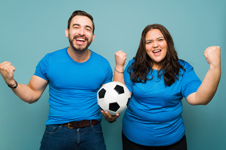 Attractive boyfriend and girlfriend celebrating the soccer game