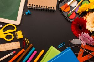 Directly above shot of school supplies on black table,Romania