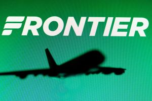 In this photo illustration, the Frontier Airlines logo is...