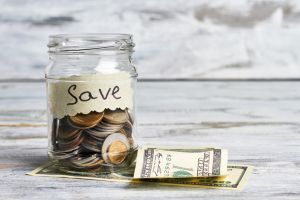 Dollars and container with coins.