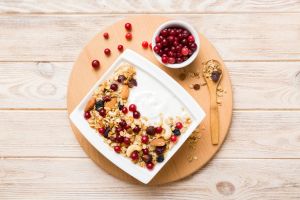 Healthy breakfast food with granola, yogurt, fruits and nuts. Dessert parfait with dried fruits for breakfast