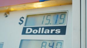 Display of rising gas prices on station pump screen, inflation, high cost of living concept