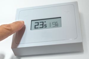 Lowering the temperature of a home thermostat due to energy crisis.