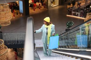 Young African woman using an escalator