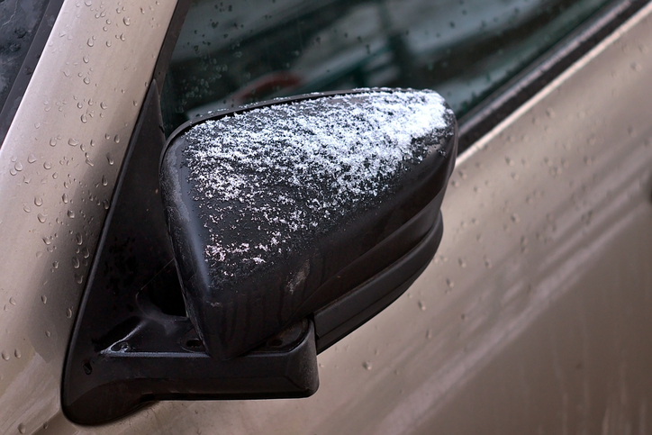 a car mirror covered in snow