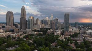 Downtown Charlotte, NC, with luxury apartments against the stormy sky at sunset.