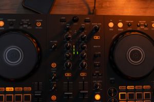 Experience the vibrant world of DJ mixing with advanced equipment in an electrifying setup.