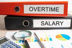 Overtime, Salary. Binder data finance report business with graph analysis in office.