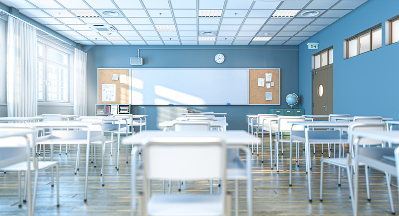 Empty classroom with white desks and whiteboard