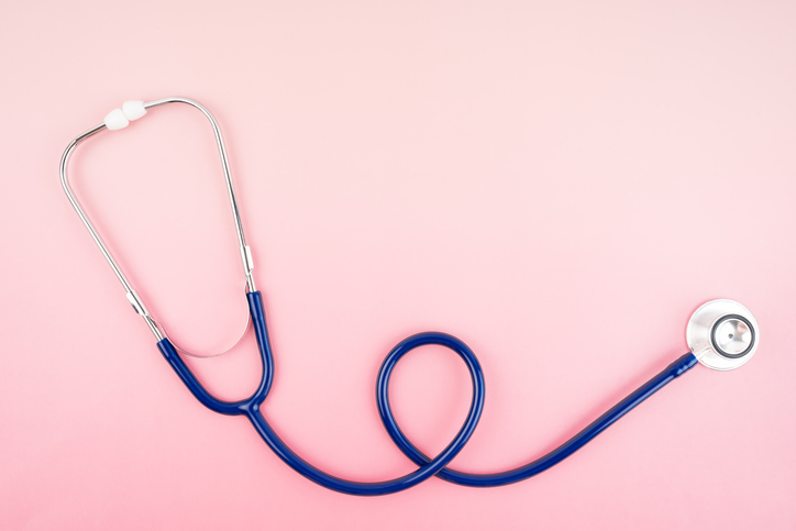 Stethoscopes on pink color background, Position with copy space.