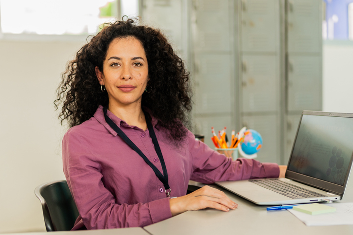 Portrait of mid adult school principal at school