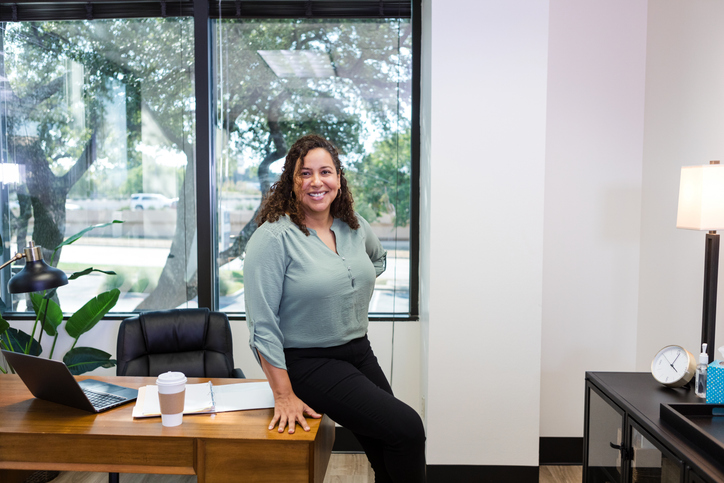 Confident Latina Therapist in Her Office, Smiling